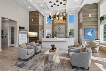 High ceiling lobby with reception desk and seating area